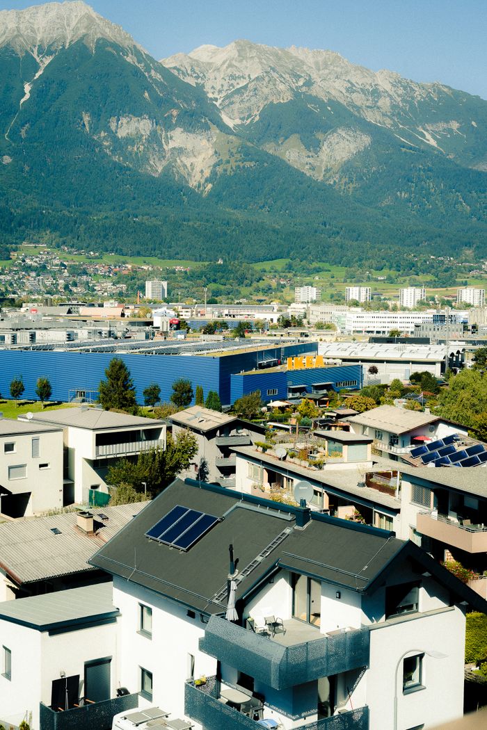 services-01 Stunning aerial view of Innsbruck, Austria, showcasing modern and traditional architecture against the majestic Alps.