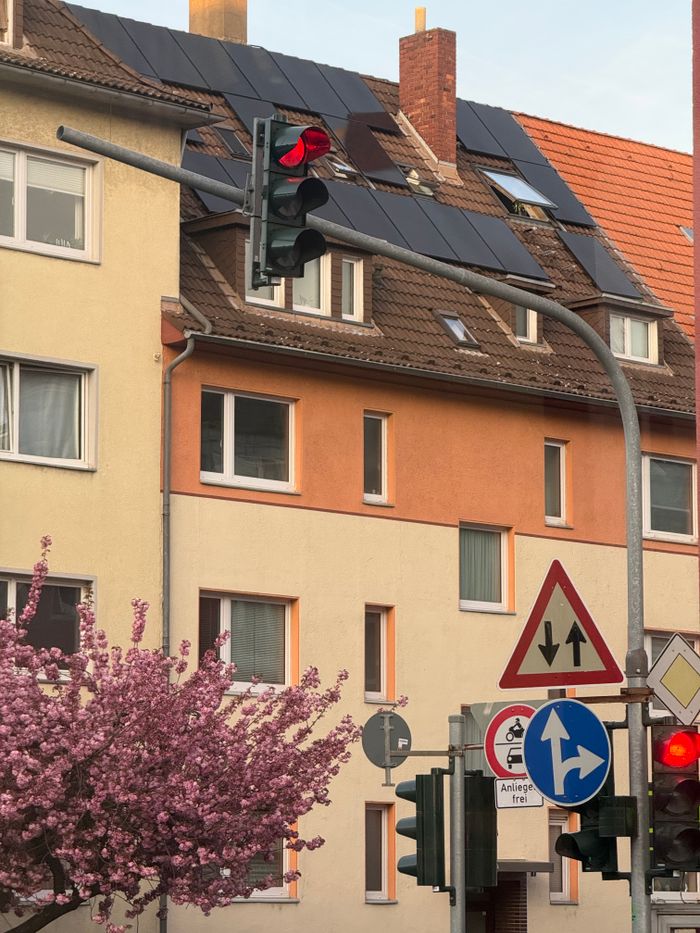 Crafting Captivating Headlines: Your awesome post title goes here Colorful urban scene featuring traffic lights and a blooming tree in front of residential buildings.